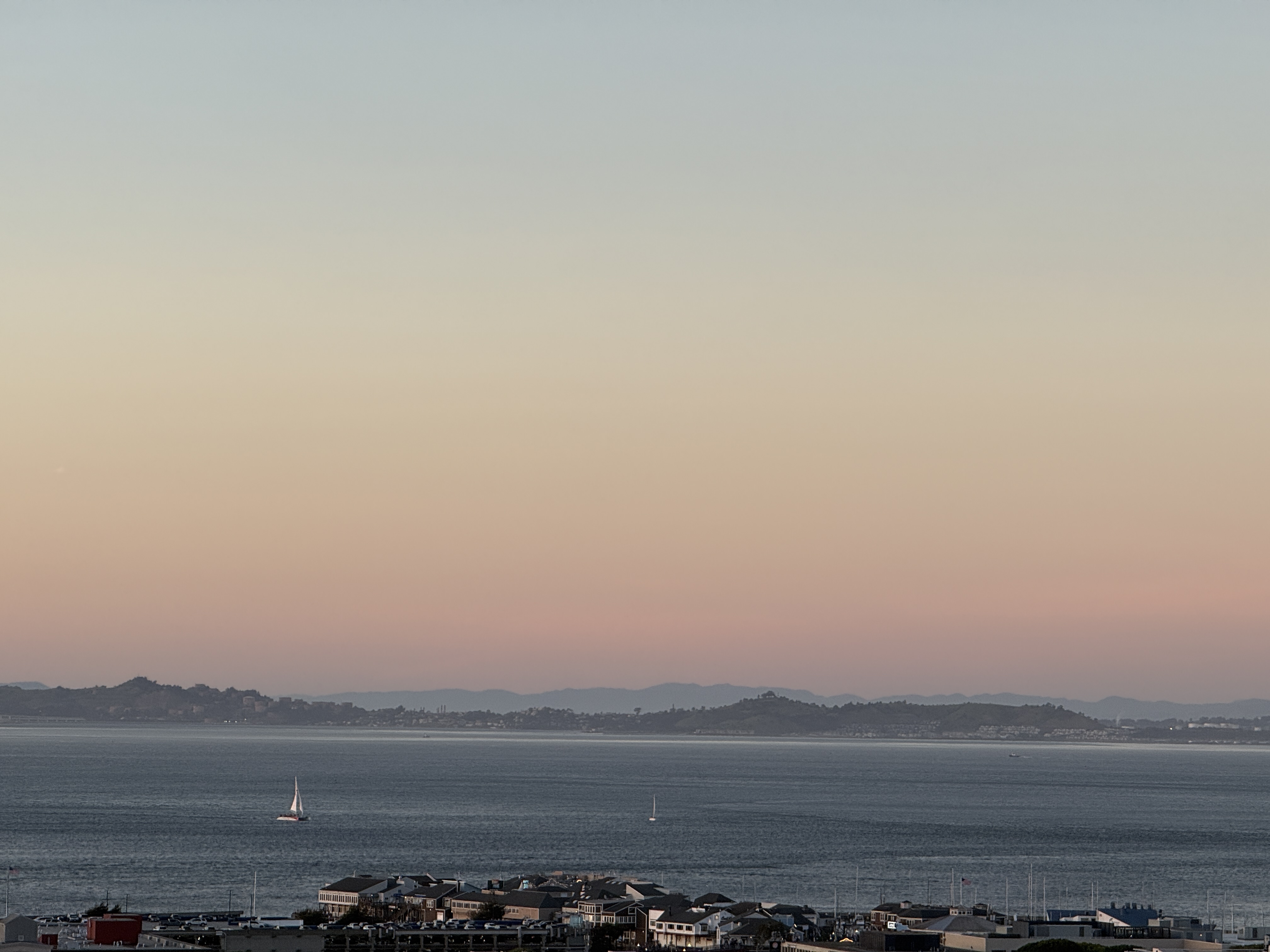 Bay at dusk with sailboats